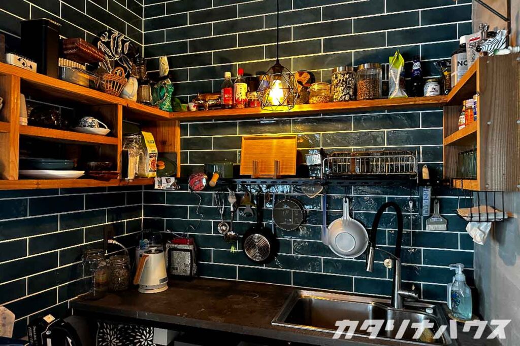 雑多でカラフルな炊事場スペース。ブルーのタイルとモルタルが個性的。